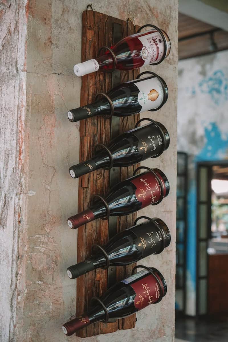 wooden wine rack hanging on the wall